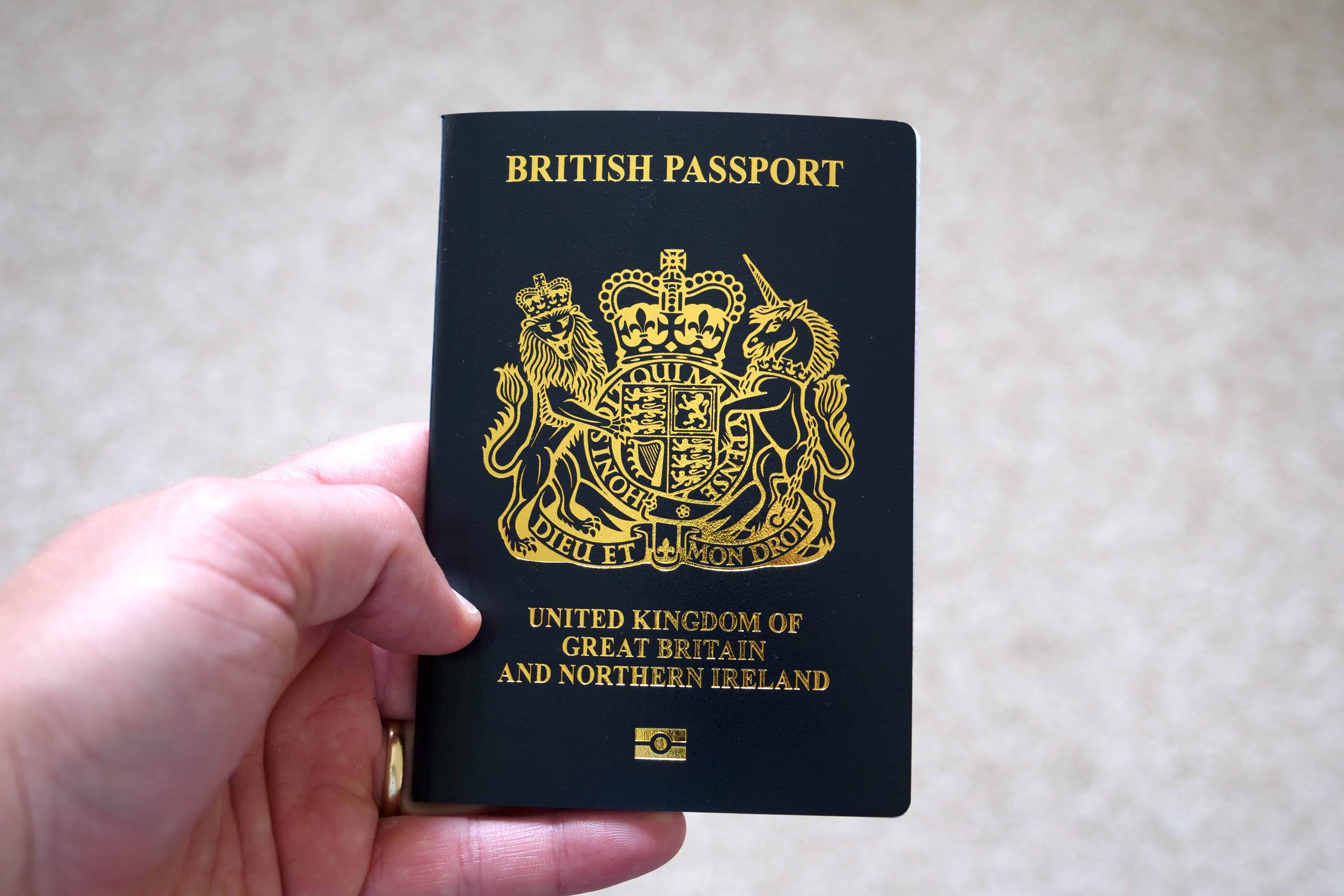 A picture of someone holding a British passport in their hand.