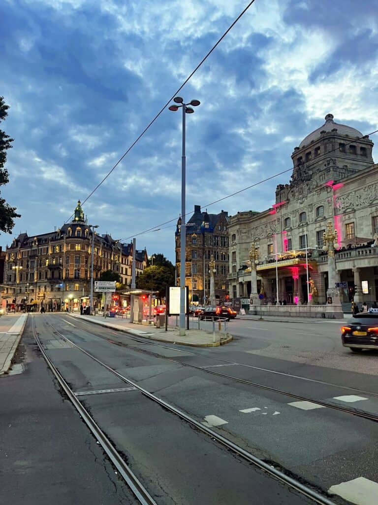 A picture of a street in Stockholm lit up at night. 