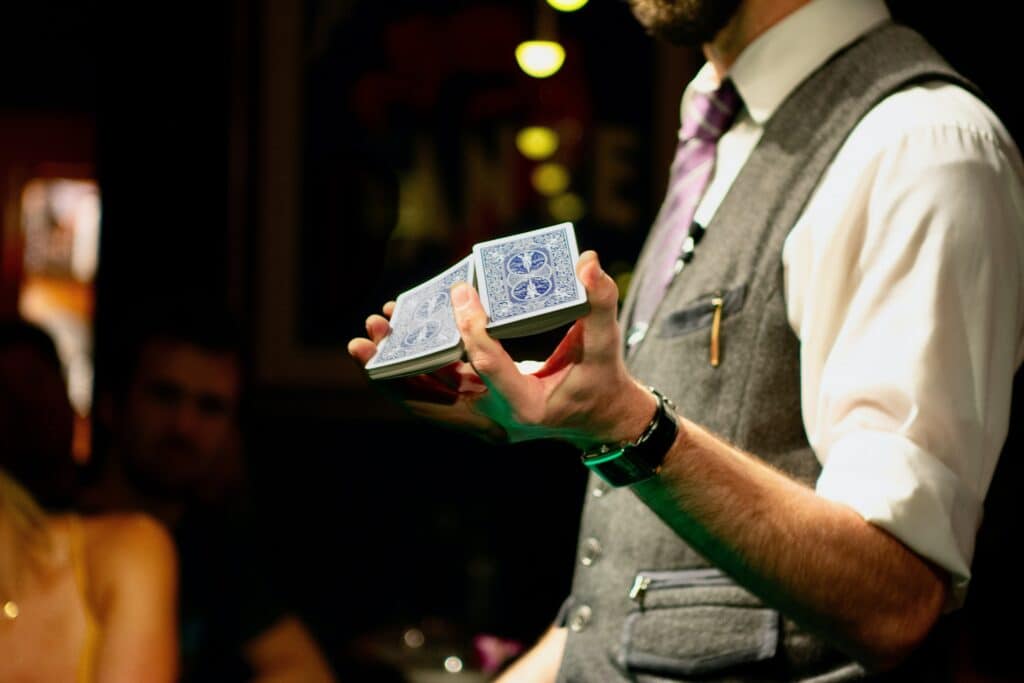 a magician holding a deck of cards