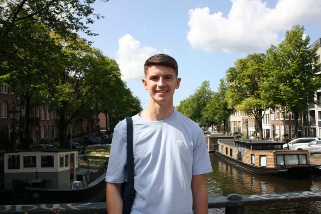 A picture of me in front of a canal in Amsterdam.
