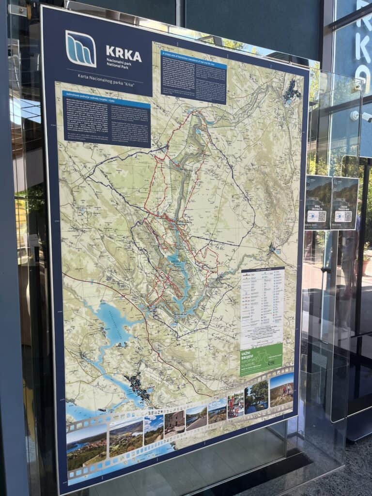 A picture of a sign showing a map of Krka National Park with different hiking trails.