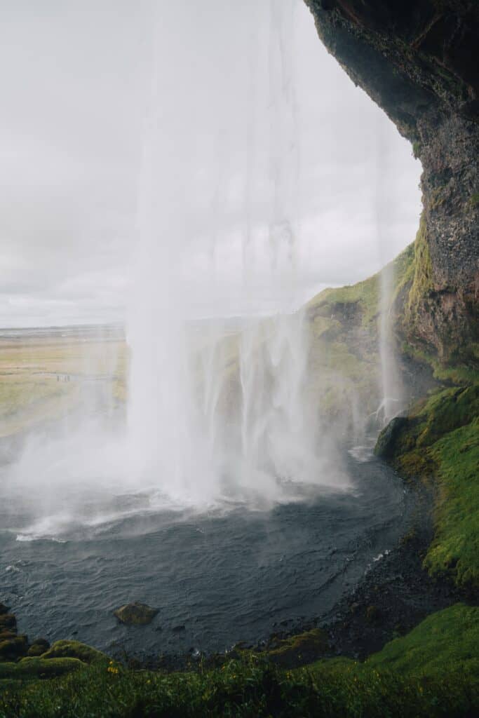 A picture taken from behind Seljalandsfoss- a key stop along the South of Iceland during day trips from Reykjavik in winter.